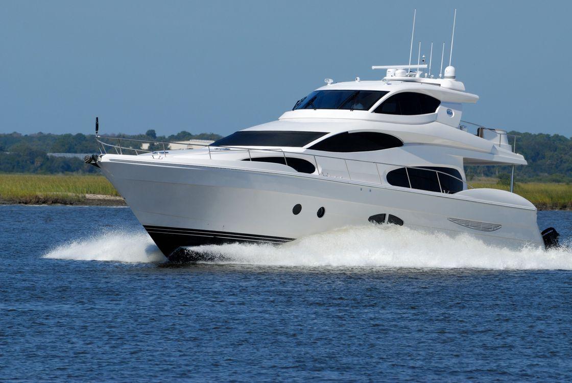 A sleek white motor yacht cruising smoothly through turquoise waters