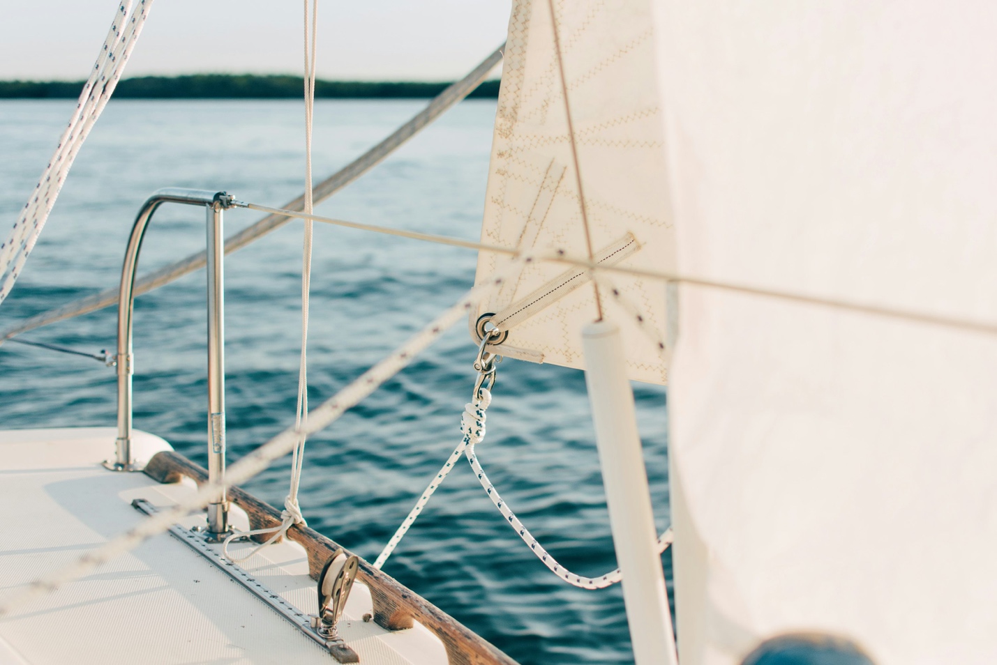 A detailed close-up of a spotless, climate-controlled yacht deck lounge area featuring pristine leather seating and immaculate custom wood finishes.