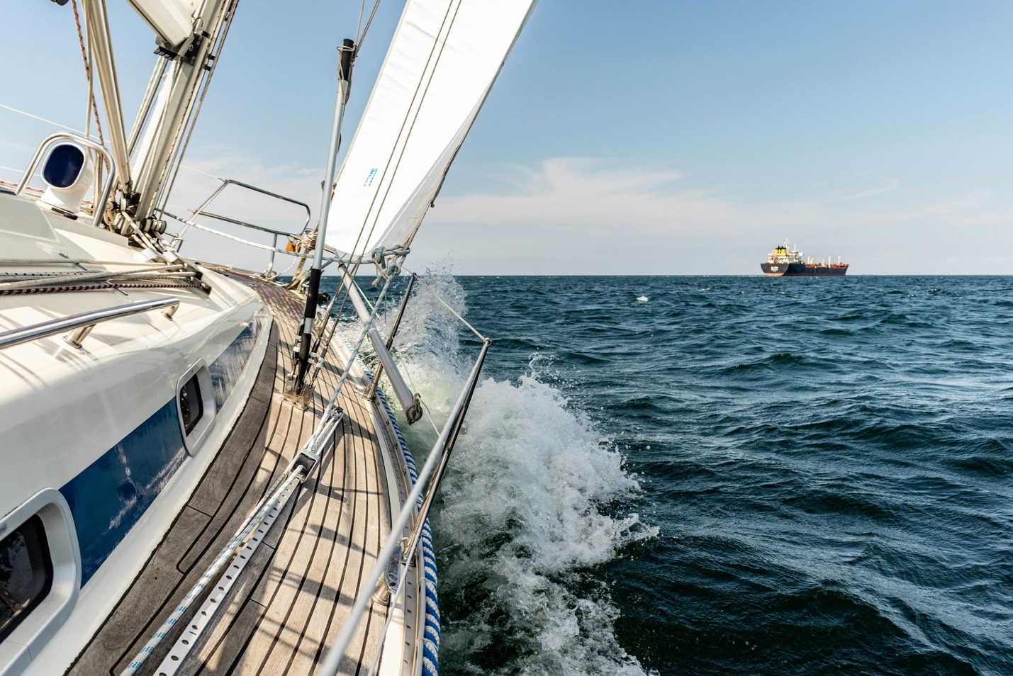 A luxury motor yacht cruising smoothly in the clear coastal waters near North Palm Beach, showcasing a brilliant hull reflection and pristine exterior finish