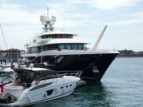 luxury motor yachts and sportfishing boats parked cleanly at a premium South Florida marina dock